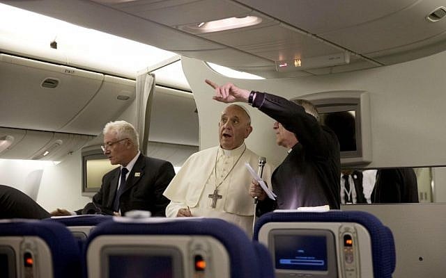 Pope Francis talks talks with Vatican Spokseman Father Federico Lombardi, right, during a press conference he held aboard the papal flight on his way back to Rome at the end of a three day trip to the Midle East, Monday, May 26, 2014 (photo credit: AP /Andrew Medichini, Pool) Pope Francis talks talks with Vatican Spokseman Father Federico Lombardi, right, during a press conference he held aboard the papal flight on his way back to Rome at the end of a three day trip to the Midle East, Monday, May 26, 2014 (photo credit: AP /Andrew Medichini, Pool)