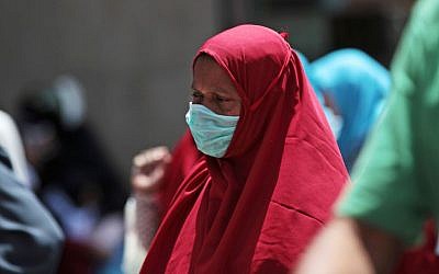 A Muslim pilgrim wears a surgical mask to prevent infection from the MERS virus, in Mecca, Saudi Arabia, May 13, 2014. (photo credit: AP/Hasan Jamali)