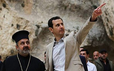 In this Sunday, April 20, 2014 file photo, released by the Syrian official news agency SANA, Syrian President Bashar Assad, right, visits the Christian village of Maaloula, near Damascus, Syria. (photo credit: AP/SANA, File) In this Sunday, April 20, 2014 file photo, released by the Syrian official news agency SANA, Syrian President Bashar Assad, right, visits the Christian village of Maaloula, near Damascus, Syria. (photo credit: AP/SANA, File)