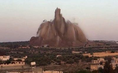 This image made from a Wednesday, May 14, 2014 video posed by Shaam News Network (SNN), an anti-Bashar Assad activist group, which has been verified and is consistent with other AP reporting, shows a bombing of a military base in Wadi Deif, northwest Syria. According to the British-based Syrian Observatory for Human Rights, rebels placed a large amount of explosives in a tunnel under the base, which is near Idlib. (Photo credit: AP /Shaam News Network via AP video) 