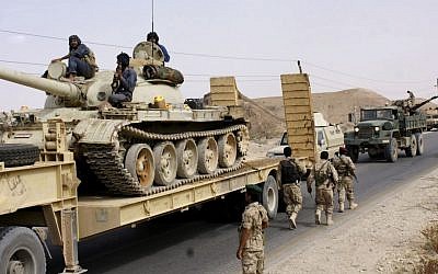 Yemeni troops move near the frontline of fighting with al-Qaeda militants in the province of Shabwa, Yemen, Tuesday, May 6, 2014. (photo credit: AP/Yemen Defense Ministry)