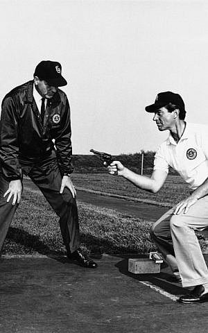 During an actual training session at the FBI Academy, TV star Efrem Zimbalist, Jr., right, perfects his pistol firing technique under the watchful eyes of an unidentified FBI instructor, in this May 21, 1965 file photo taken in Quantico, Va. (AP Photo, File)