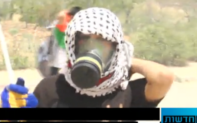 Footage from Walla! News camerman Daniel Book's coverage of the Beitunia demonstration at which Avi Issacharof was attacked on May 16, 2014 (Walla! News screenshot) Footage from Walla! News camerman Daniel Book's coverage of the Beitunia demonstration at which Avi Issacharof was attacked on May 16, 2014 (Walla! News screenshot)