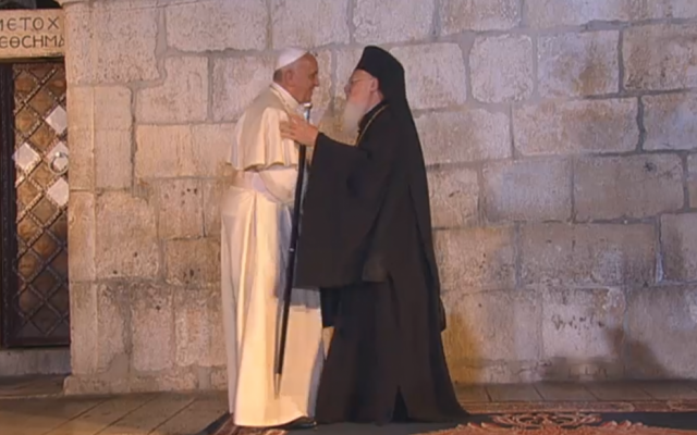 Pope Francis and Bartholomew I embrace outside the Church of the Holy Sepulchre (screen capture: GPO)