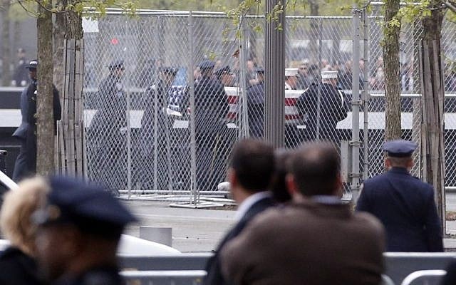 Officials acting as pallbearers carry a casket with the unidentified remains of victims of the Sept. 11, 2001 attacks as they are returned to the World Trade Center site, Saturday, May 10, 2014, in New York. (Photo credit: AP/Julio Cortez)