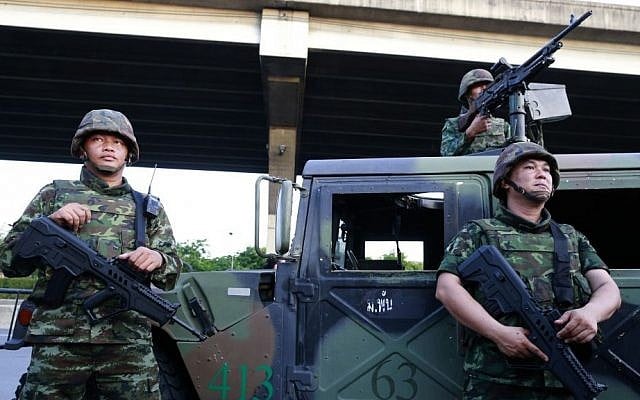 Thai soldiers take up position on a street outside the Centre for the Administration of Peace and Order (CAPO) after soldiers were sent in to seize the center Tuesday, May 20, 2014 in Bangkok, Thailand. (photo credit: AP Photo/Wason Wanichakorn) Thai soldiers take up position on a street outside the Centre for the Administration of Peace and Order (CAPO) after soldiers were sent in to seize the center Tuesday, May 20, 2014 in Bangkok, Thailand. (photo credit: AP Photo/Wason Wanichakorn)
