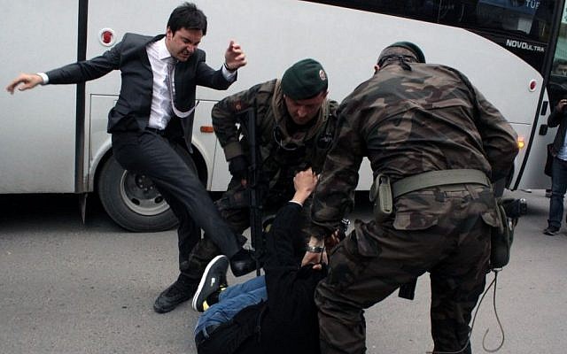 A person identified by Turkish media as Yusuf Yerkel, adviser to Turkish Prime Minister Recep Tayyip Erdogan, kicks a protester already held by special forces police members during Erdogan's visiting Soma, Turkey, on May 14, 2014. (photo credit: AP Photo/Depo Photos) A person identified by Turkish media as Yusuf Yerkel, adviser to Turkish Prime Minister Recep Tayyip Erdogan, kicks a protester already held by special forces police members during Erdogan's visiting Soma, Turkey, on May 14, 2014. (photo credit: AP Photo/Depo Photos)