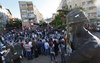 Anti-government protesters rally near the monument for the town's miners in Soma, Turkey where the mine accident took place, Friday, May 16, 2014. Hundreds of protesters took part in the march against the government and there were clashes with the police forces. An explosion and fire at a coal mine in Soma, some 250 kilometers (155 miles) south of Istanbul, killed hundreds of workers, authorities said, in one of the worst mining disasters in Turkish history. (photo credit: AP/Lefteris Pitarakis)