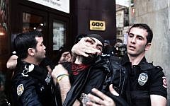 Riot police detain a protester as they use water cannons and teargas to disperse people who were protesting the Soma mine accident that killed 301 miners, in Istanbul, Turkey, Saturday, May 17, 2014. (photo credit: AP Photo)