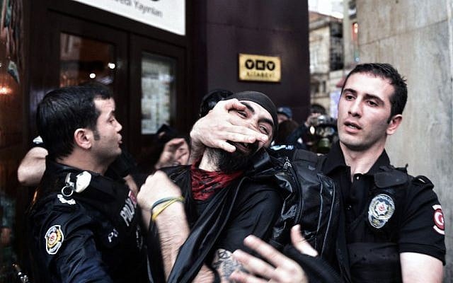 Riot police detain a protester as they use water cannons and teargas to disperse people who were protesting the Soma mine accident that killed 301 miners, in Istanbul, Turkey, Saturday, May 17, 2014. (photo credit: AP Photo) Riot police detain a protester as they use water cannons and teargas to disperse people who were protesting the Soma mine accident that killed 301 miners, in Istanbul, Turkey, Saturday, May 17, 2014. (photo credit: AP Photo)
