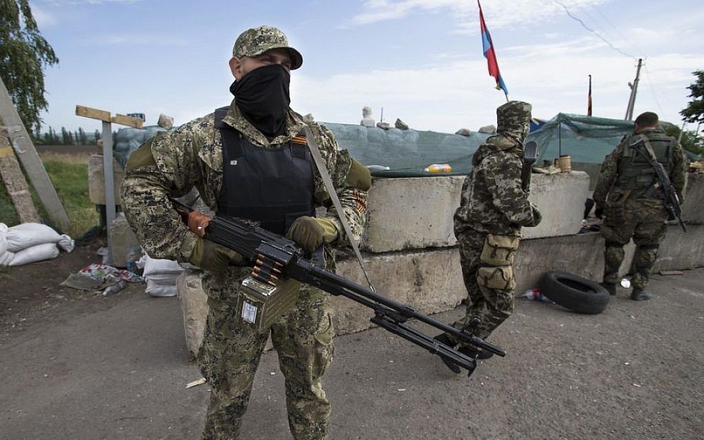 Pro-Russian armed militants guard a checkpoint blocking the major highway which links Kharkiv, outside Slovyansk, Ukraine, Saturday, May 24, 2014. (AP Photo/Alexander Zemlianichenko) Pro-Russian armed militants guard a checkpoint blocking the major highway which links Kharkiv, outside Slovyansk, Ukraine, Saturday, May 24, 2014. (AP Photo/Alexander Zemlianichenko)