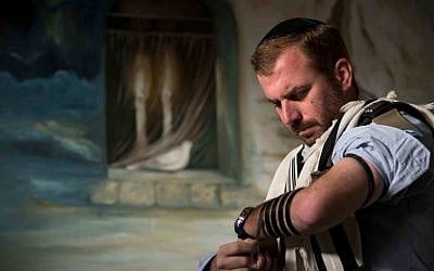 Jewish ultra-Orthodox military captain Moshe Prigan, 30, lays phylacteries for his morning prayer at home in the ultra-Orthodox Jewish town of Bnei Brak, near Tel Aviv. (AP Photo/Oded Balilty) Jewish ultra-Orthodox military captain Moshe Prigan, 30, lays phylacteries for his morning prayer at home in the ultra-Orthodox Jewish town of Bnei Brak, near Tel Aviv. (AP Photo/Oded Balilty)