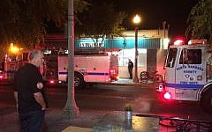 Fire trucks are parked outside the IV Deli Mart on Pardell Road in Isla Vista, Calif., Friday, May 23, 2014, after a drive-by shooter went on a rampage near a Santa Barbara university campus that left seven people dead, including the attacker, and seven others wounded (photo credit: APThe Daily Nexus, Daniel Slovinsky)