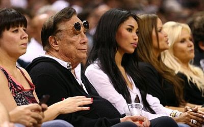 Los Angeles Clippers owner Donald Sterling is pictured here with V. Stiviano to his left at a 2013 basketball game. (photo credit: Ronald Martinez/Getty Images/JTA)