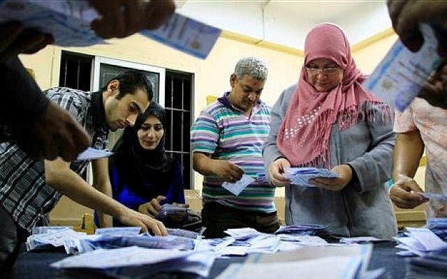 Election workers count ballots at a counting center in Cairo, Wednesday, May 28, 2014 (photo credit: AP /Lobna Tarek, El Shorouk Newspaper) Election workers count ballots at a counting center in Cairo, Wednesday, May 28, 2014 (photo credit: AP /Lobna Tarek, El Shorouk Newspaper)