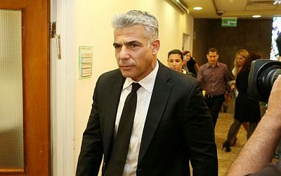Finance Minister Yair Lapid arrives at the Prime Minister's Office in Jerusalem, April 27, 2014 (photo credit: Amit Shabi/POOL/Flash90)