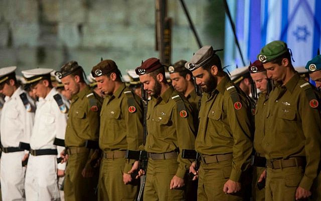 Israeli soldiers stand at attention and bow their heads during a Memorial Day ceremony for Israel's fallen soldiers at the Western Wall, May 4, 2014. (photo credit: Yonatan Sindel/Flash 90) Israeli soldiers stand at attention and bow their heads during a Memorial Day ceremony for Israel's fallen soldiers at the Western Wall, May 4, 2014. (photo credit: Yonatan Sindel/Flash 90)