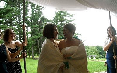 Idit Klein, right, the executive director of Keshet, married Jordan Namerow under a chuppah at their 2011 wedding in Massachusetts, which was officiated by two rabbis. (photo credit: courtesy of Idit Klein)