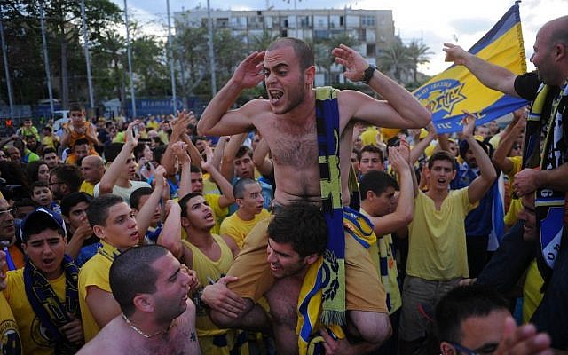 Thousands of Maccabi Tel Aviv basketball fans celebrate the basketball team's arrival at Rabin Square in Tel Aviv on May 19, 2014 after the Israeli team won the Euroleague Finals, beating Real Madrid with a score of 98-86. (photo credit: Flash90) Thousands of Maccabi Tel Aviv basketball fans celebrate the basketball team's arrival at Rabin Square in Tel Aviv on May 19, 2014 after the Israeli team won the Euroleague Finals, beating Real Madrid with a score of 98-86. (photo credit: Flash90)