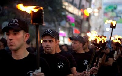 Palestinians hold torches marking the 66th anniversary of "Nakba," or “catastrophe” referring to their uprooting in the war over Israel's 1948 creation, in the West Bank city of Ramallah, Wednesday, May 14, 2014 (photo credit: AP/Majdi Mohammed) 