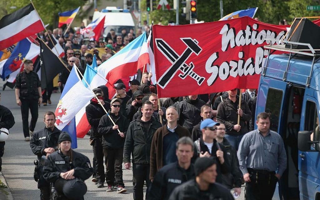 Some 250 supporters of the far-right National Democratic Party marching on May Day in Rostock, Germany, are accompanied by riot police, May 1, 2014. (Sean Gallup/Getty Images/via JTA)