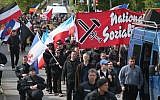 Some 250 supporters of the far-right National Democratic Party marching on May Day in Rostock, Germany, are accompanied by riot police, May 1, 2014. (Sean Gallup/Getty Images/via JTA)
