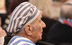 A Holocaust survivor seen during a ceremony at the former Auschwitz-Birkenau concentration and extermination camp in Poland. (photo credit: Isaac Harari/Flash90)