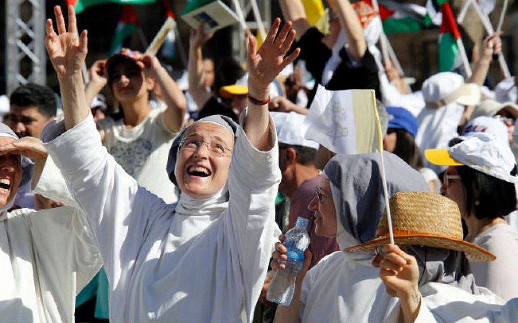 Christian nuns cheers as they wait for Pope Francis (not pictured) leading an open-air mass in Manger Square, next the Nativity Church, in the West Bank city of Bethlehem on May 25, 2014 (photo credit: Sliman Khader/Flash90)