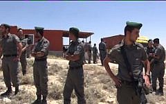 Border Police outside a home slated for destruction in Ma'ale Rehavam Wednesday. (Screen capture: Israel National News)