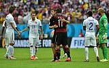 Germany's forward Thomas Mueller (C-L) hugs Germany's forward Miroslav Klose after a Group G football match between US and Germany at the Pernambuco Arena in Recife during the 2014 FIFA World Cup on June 26, 2014. (photo credit: AFP/Nelson Almeida)
