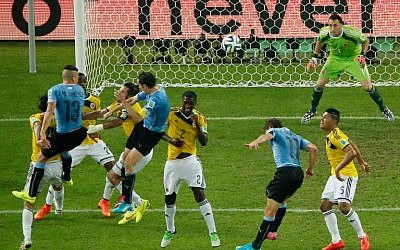Uruguay's forward Christian Stuani (2R) heads the ball as Uruguay's defender Diego Godin (4L) and Uruguay's defender Jose Maria Gimenez (2L) defend against Colombia's midfielder Alexander Mejia (FRONT) Colombia's defender and captain Mario Alberto Yepes (3R) Colombia's defender Cristian Zapata (4L) and Colombia's midfielder Alexander Mejia (R) during the Round of 16 football match between Colombia and Uruguay at The Maracana Stadium in Rio de Janeiro on June 28, 2014, during the 2014 FIFA World Cup. (photo credit: AFP/FABRIZIO BENSCH/POOL)