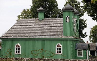 A devastated wooden mosque by graffiti is pictured on June 29, 2014 in Kruszyniany, Poland. (photo credit: AFP PHOTO/ PAP/Artur Reszko)