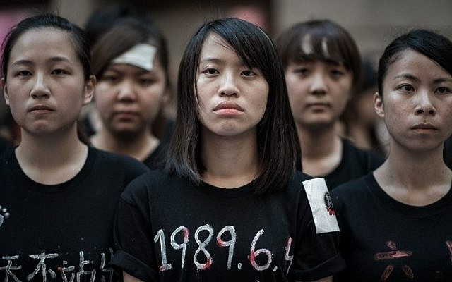 Students look ahead before singing to commemorate China's 1989 Tiananmen Square events ahead of a candlelight vigil in Hong Kong on June 4, 2014. (photo credit: Philippe Lopez/AFP) Students look ahead before singing to commemorate China's 1989 Tiananmen Square events ahead of a candlelight vigil in Hong Kong on June 4, 2014. (photo credit: Philippe Lopez/AFP)