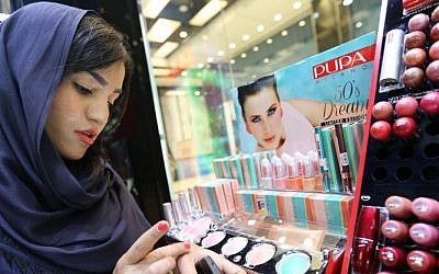 Illustrative: A woman checks make up at a cosmetics shop in northern Tehran on May 6, 2014. (photo credit: AFP/Atta Kenare)