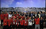 Palestinian Authority President Mahmud Abbas receives, in his office in the West Bank city of Ramallah on June 1, 2014, the Palestinian national football team which won the AFC Challenge Cup. (photo credit: AFP/Abbas Momani)