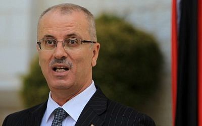 Palestinian Authority Prime Minister Rami Hamdallah speaks during a press conference following the first cabinet meeting of the new Palestinian unity government in the West Bank city of Ramallah on June 3, 2014. (photo credit: Abbas Momani/AFP)