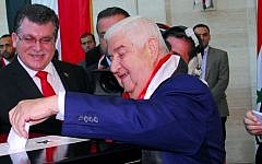 A handout picture released by the official Syrian Arab News Agency (SANA) shows Syrian Foreign Minister Walid Muallem casting his vote in the country's presidential elections at a polling station in Damascus on June 3, 2014 (Photo credit: AFP PHOTO / HO / SANA)