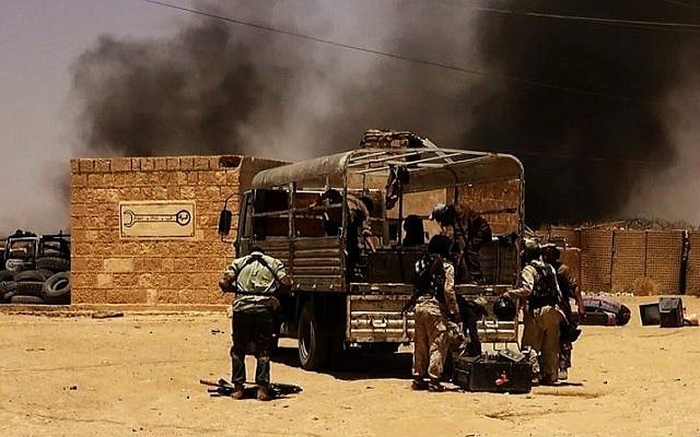 An image allegedly showing Islamic State of Iraq and the Levant (ISIL) militants taking position at a Iraqi border post on the Syrian-Iraqi border, June 9, 2014 . (photo credit: AFP/HO/ALBARAKA NEWS) 