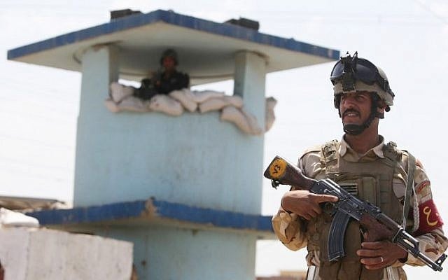 An Iraqi soldier stands guard at a checkpoint in the Iraqi town of Taji, at the entrance of Baghdad, on June 13, 2014, as security forces are bolstering defenses in the capital (Ahmad al-Rubaye/AFP) An Iraqi soldier stands guard at a checkpoint in the Iraqi town of Taji, at the entrance of Baghdad, on June 13, 2014, as security forces are bolstering defenses in the capital (Ahmad al-Rubaye/AFP)