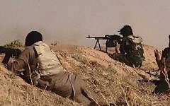 An image made available by the jihadist Twitter account Al-Baraka News on June 13, 2014, allegedly shows Islamic State of Iraq and the Levant militants clashing with Iraqi soldiers at an undisclosed location close to the Iraqi-Syrian border, in the district of Sinjar, northwest Iraq. (photo credit: AFP/HO/Al-Baraka News)