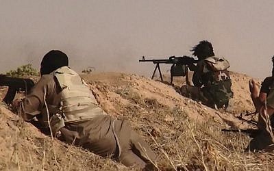 An image made available by the jihadist Twitter account Al-Baraka News on June 13, 2014, allegedly shows Islamic State of Iraq and the Levant militants clashing with Iraqi soldiers at an undisclosed location close to the Iraqi-Syrian border, in the district of Sinjar, northwest Iraq. (photo credit: AFP/HO/Al-Baraka News)