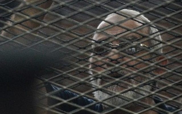 Egyptian Muslim Brotherhood leader Mohammed Badie stands behind the defendants cage during his trial on June 18, 2014 (Photo credit: Mohammed el-Shahed/AFP) Egyptian Muslim Brotherhood leader Mohammed Badie stands behind the defendants cage during his trial on June 18, 2014 (Photo credit: Mohammed el-Shahed/AFP)