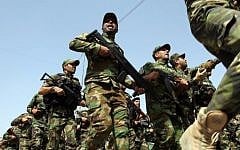 Illustrative photo of Iraqi Shiite fighters parading with their weapons in Baghdad (Photo credit: Ali al-Saadi/AFP)