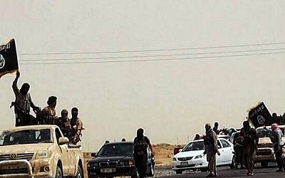 An image uploaded on June 14, 2014 on the jihadist website Welayat Salahuddin allegedly shows militants of the Islamic State of Iraq and the Levant (ISIL) driving on a street at unknown location in the Salaheddin province. (photo credit: AFP PHOTO / HO / WELAYAT SALAHUDDIN)