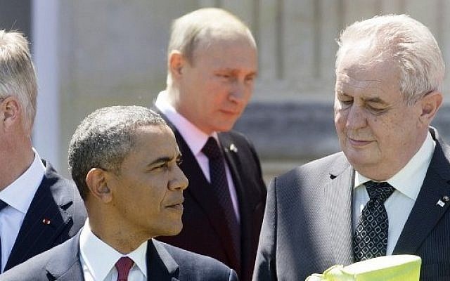 Russian President Vladimir Putin seen behind US President Barack Obama during a group photo of world leaders attending the D-Day 70th Anniversary ceremonies at Chateau de Benouville in Benouville, France, June 6, 2014. (Saul Loeb/AFP) Russian President Vladimir Putin seen behind US President Barack Obama during a group photo of world leaders attending the D-Day 70th Anniversary ceremonies at Chateau de Benouville in Benouville, France, June 6, 2014. (Saul Loeb/AFP)