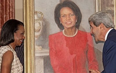 US Secretary of State John Kerry (right) with former US secretary of state Condoleezza Rice during a ceremony to unveil the official painting of her that will hang in the State Department, June 2014. (photo credit: AFP/Paul J. Richards)