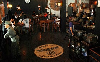 A Nazi swastika insignia sign on the floor decorates the interior of the reopened SoldatenKaffee in Bandung city, western Java island on June 21, 2014. (photo credit: AFP/TIMUR MATAHARI)