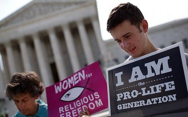 Pro-life activists gather outside the US Supreme Court in Washington, DC, on June 26, 2014. (photo credit: Win McNamee/Getty Images/AFP) Pro-life activists gather outside the US Supreme Court in Washington, DC, on June 26, 2014. (photo credit: Win McNamee/Getty Images/AFP)
