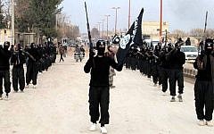 This undated file image posted on a militant website on Tuesday, January 14, 2014 shows fighters from the Islamic State marching in Raqqa, Syria.  (photo credit: AP/militant website, File)