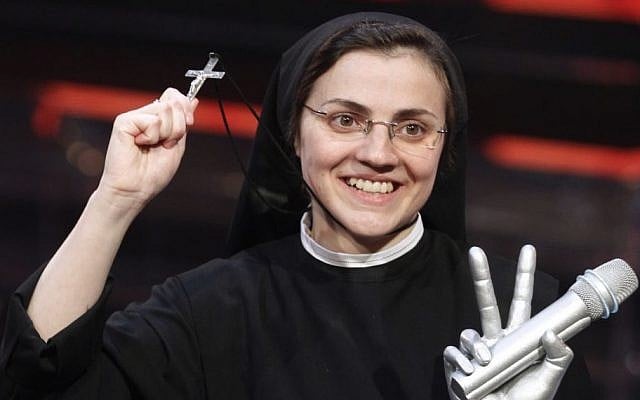 Sister Cristina Scuccia poses with the trophy and holding the cross on the stage after winning the final of the Italian version of the TV talent show "The Voice" in Milan, Italy, Thursday, June 5, 2014. With her full habit, sensible shoes and cheering nuns in her camp, Sister Cristina Scuccia made it to Thursday's finals of the Italian version of "The Voice" after capturing attention, and millions of YouTube viewers, with her first-round performance in March. (AP Photo/Luca Bruno) Sister Cristina Scuccia poses with the trophy and holding the cross on the stage after winning the final of the Italian version of the TV talent show "The Voice" in Milan, Italy, Thursday, June 5, 2014. With her full habit, sensible shoes and cheering nuns in her camp, Sister Cristina Scuccia made it to Thursday's finals of the Italian version of "The Voice" after capturing attention, and millions of YouTube viewers, with her first-round performance in March. (AP Photo/Luca Bruno)